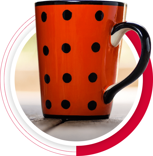 A close up of a coffee cup with black dots