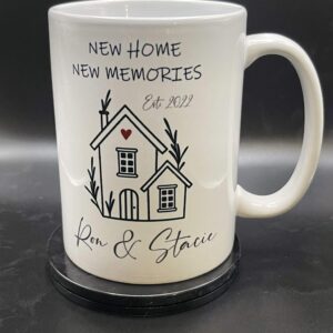 A mug with the words new home, new memories and a house.