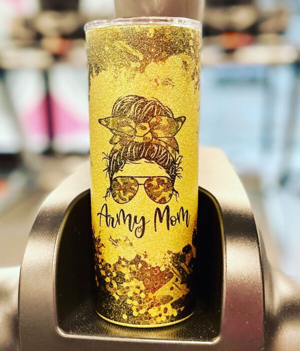 A yellow candle with an image of a woman wearing sunglasses.