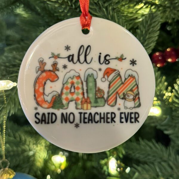 A Christmas tree ornament with a text about teacher on it