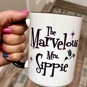 A woman holding the marvelous Mr. sippie logo cup